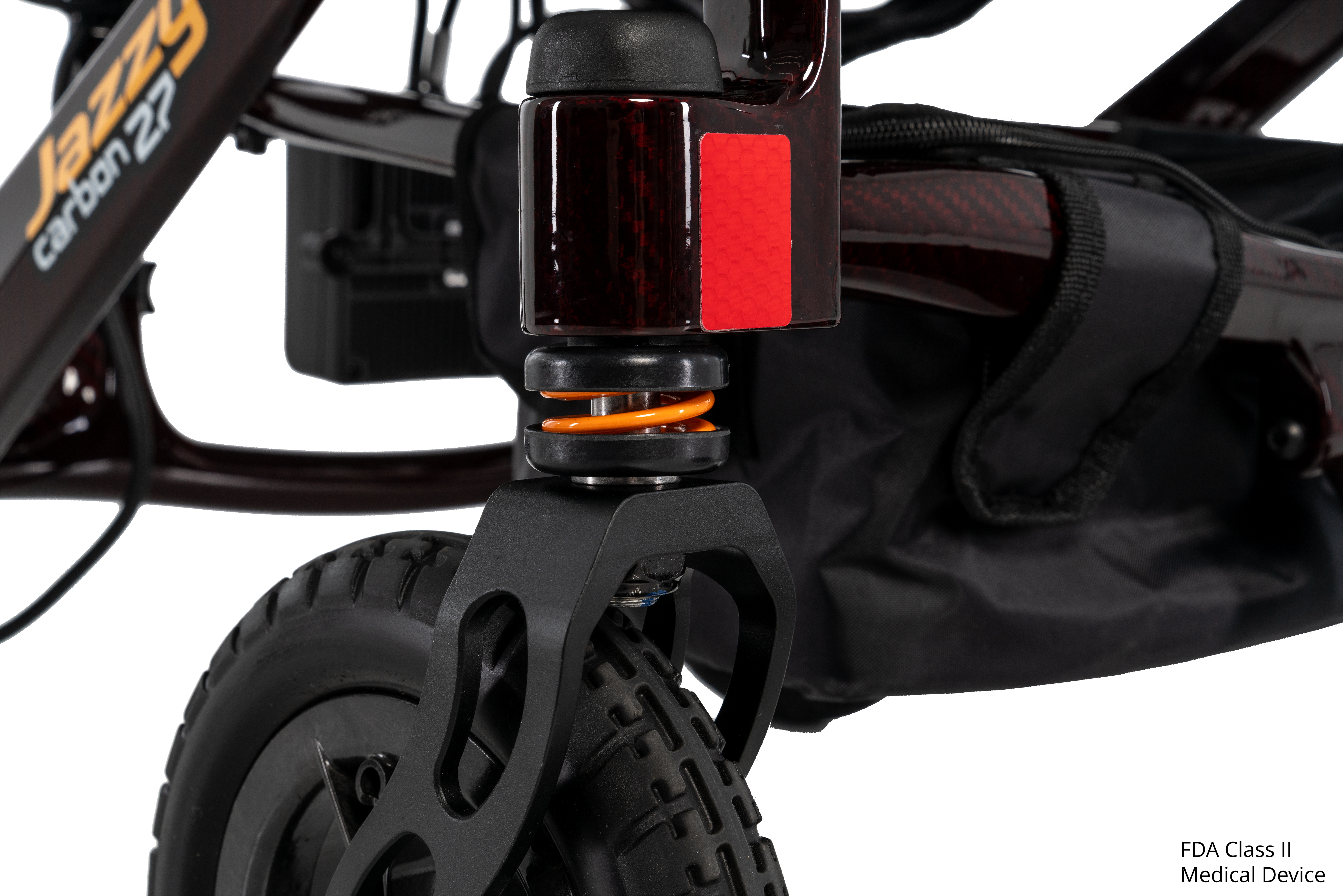 Close-up of the full front suspension on the Pride Jazzy Carbon 27 power wheelchair in Black Cherry